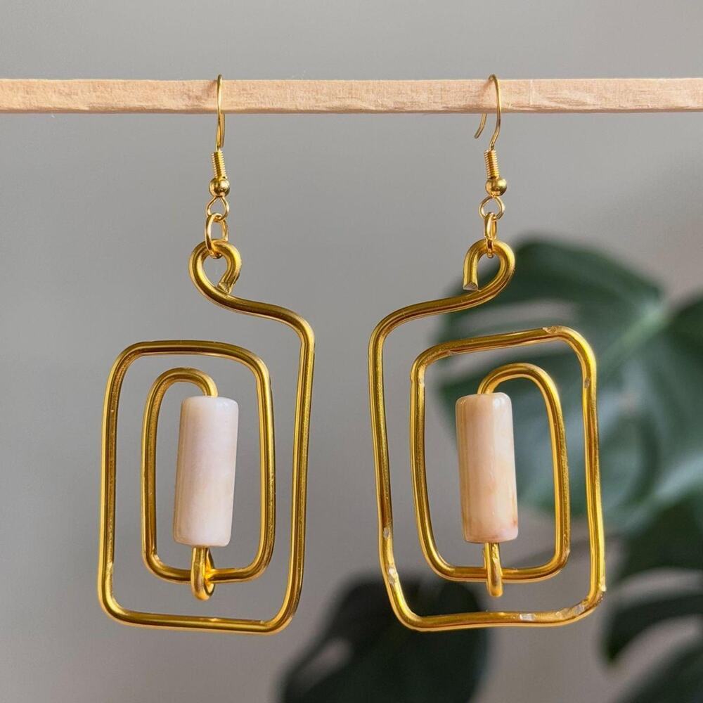 handmade gold wire spiral earrings with cream colored tube beads